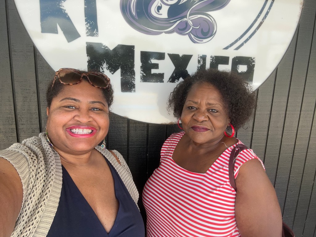 Me and mom standing in front of a mediocre restaurant