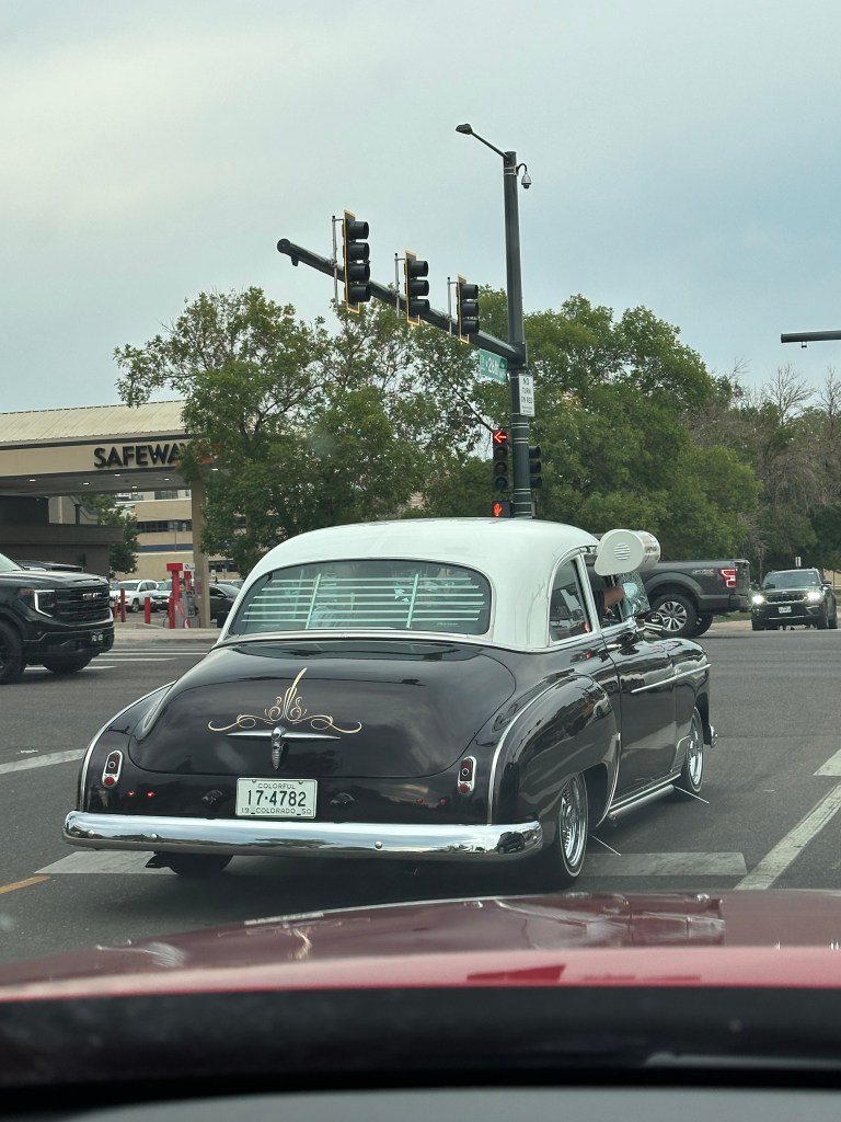 Image of an antique car with a black body and white top