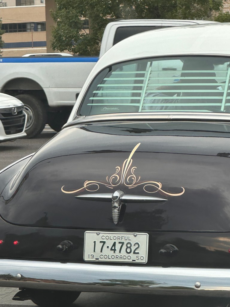 Image of an antique car with a black body and white top