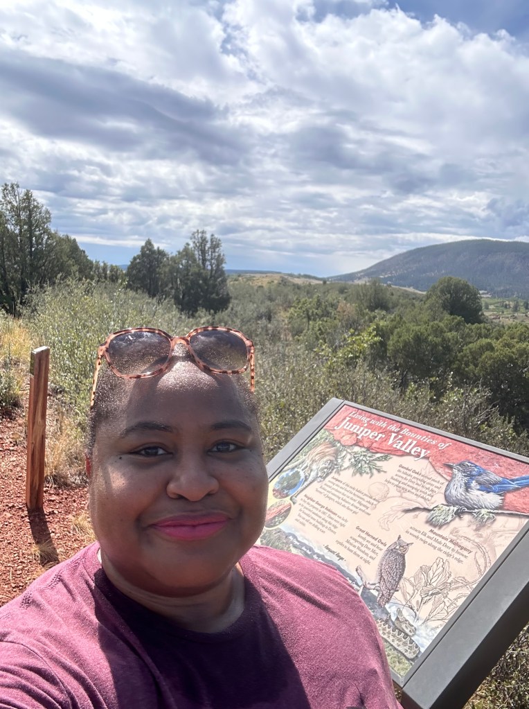 The author standing in front of the Juniper Valley information sign